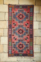 An antique carpet on the wall. Caucasian folk crafts and art
