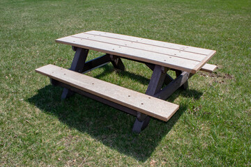 A picnic table on green park lawn.