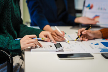 Close-up of hands working on UX/UI design at a desk. Papers with wireframes, prototypes, and mockups detail user flows, personas, and A/B testing, ensuring usability and responsive design.