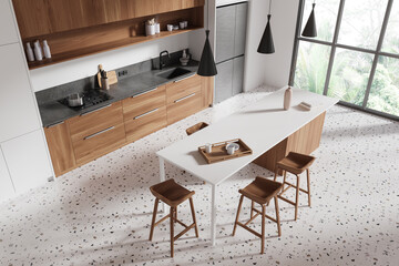 Top view of hotel kitchen interior with bar counter and cooking cabinet, window