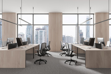 Modern office workspace with large windows and cityscape view, featuring desks, chairs, and computers. 3D rendering of a sleek, professional environment