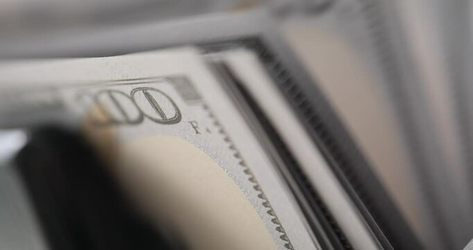 Banknote counter efficiently processes and counts dollar bills. Machine smoothly handles e task of tallying money exchanged by customers