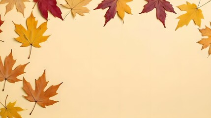 Fototapeta premium Top view of dry maple autumn leaves on pastel yellow background with ample copy space for text