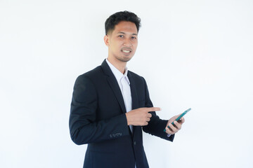 Asian businessman smiling while pointing to mobile phone that he hold