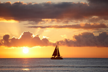 Sunset, seascape and sail boat in ocean, tropical island and Hawaii with skyline in nature, harmony and peace. Holiday, trip and travel for vacation as wallpaper, background or texture for adventure