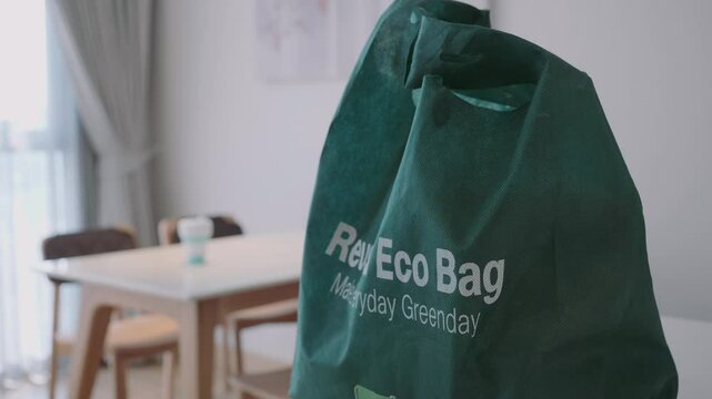 A green bag that says Reused Eco Bag on it