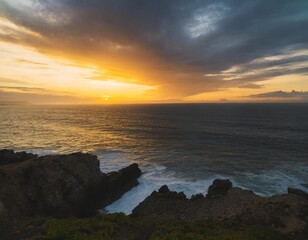 Beautiful colorful sunset and vivid dramatic sky at rocky shore of the Atlantic ocean.