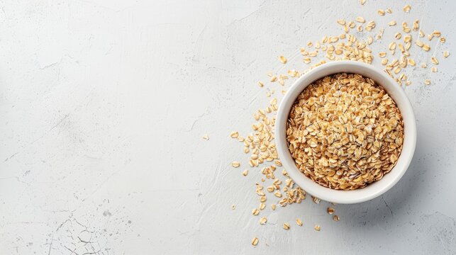 Oats in white bowl on plain background with space for text