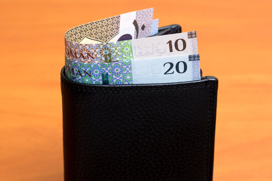 Omani rial in the black wallet