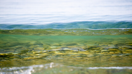 A sea wave breaks against the rocks, water splashes in the sky. Tidal wave.