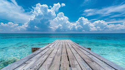Fototapeta premium Serene turquoise ocean view with wooden dock leading to clear water. Perfect for travel, relaxation, and escapism themes. Vivid blue sky with clouds create a tranquil scene. Stock photo. AI
