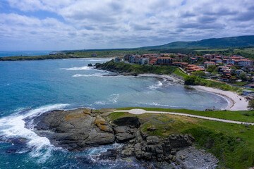 Obraz premium Aerial view near Tsarevo with church near by and waves hitting the rocks 