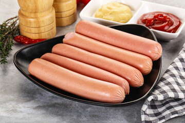 Boiled sausages with ketchup and mustard