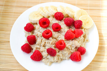 Oatmeal with pieces of raspberry and banana
