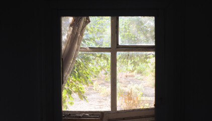 Sunlight on the window of an old abandoned house. Sunlight inside a dark house