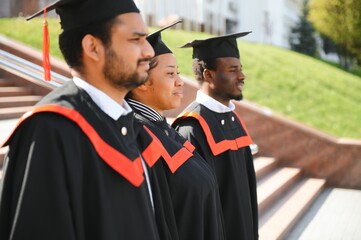 Diverse international students with diplomas attending graduation ceremony, happy multiracial group of students