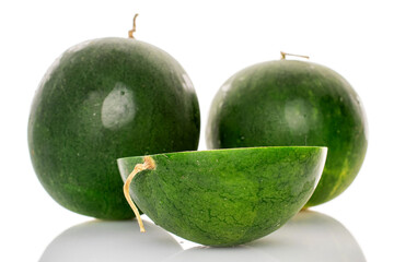 One half of sweet watermelon and two whole, isolated on white background.