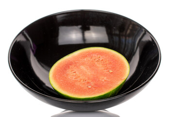 One half of a sweet watermelon in a black ceramic plate, isolated on a white background.