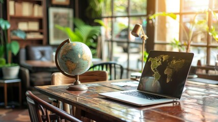 A laptop computer with a world map on the screen sits on a wooden desk, next to a globe, symbolizing international business, travel, exploration, and connectivity.