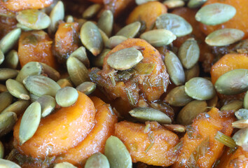 Grated or shredded carrots and pumpkin seeds organic meal. Homemade healthy carrot lunch food concept