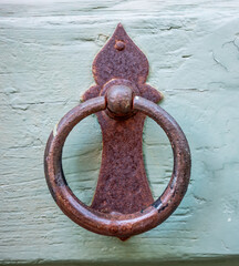Ancient door knocker dating back to the 19th century. Copyspace around.