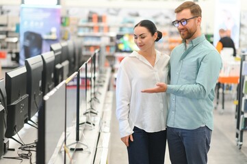 Couple buying television at store