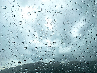 Rain particles, drops and precipitation on the glassartistic stance of raindrops on glass