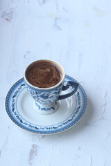 Turkish coffee in a blue cup on a white background