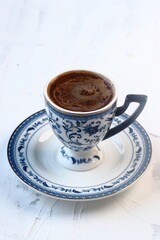 Turkish coffee in a blue cup on a white background