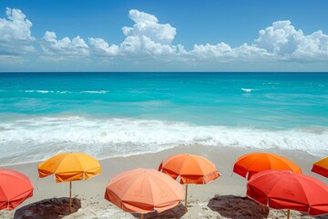 Brightly colored umbrellas on a sandy beach, with the sun high in the sky and clear, inviting ocean waters beyond