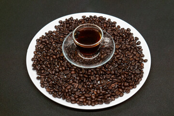 Espresso Americano in a glass cup with fresh coffee beans scattered around Isolated White Background