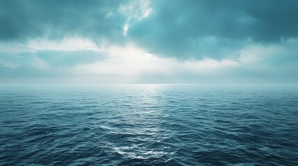 Obraz premium A serene seascape with a calming blue sky and shimmering water. The sun peeks through the clouds, casting a gentle glow.
