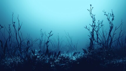 Fototapeta premium Silhouettes of skeletal trees rise from a hazy, blue underwater landscape.
