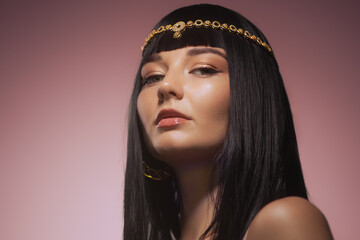 Cleopatra Cosplay Woman with Gold Headband and Elegant Makeup