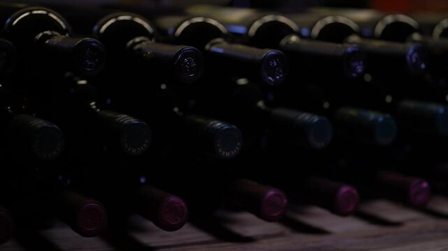 Close-Up View of Wine Bottles in a Dark Cellar