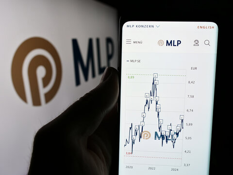 Stuttgart, Germany - 07-15-2024: Person holding mobile phone with website of German financial services company MLP SE in front of business logo. Focus on center of phone display.