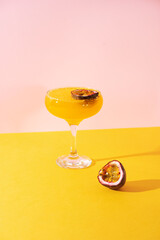 Cocktail spritz with passion fruit on blue background