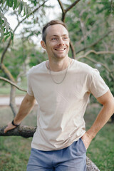 Fashion portrait of man near tree with bracelet