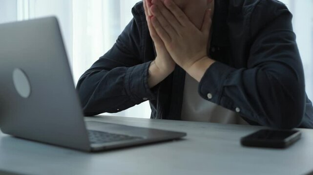 Shocked frustrated European businessman student feeling stressed looking at computer screen worried about problem reading bad online news getting failed exam results