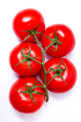 Branch with red tomatoes on a white background, top view
