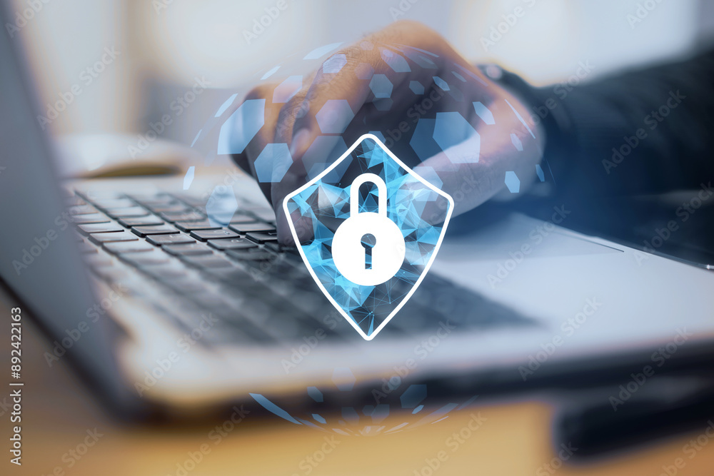 Poster close-up of a person typing on a laptop with a cybersecurity lock icon overlay.