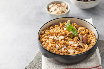 Crispy homemade granola with sliced almonds in a bowl. Healthy food. Copy space