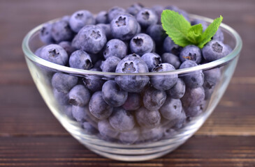 Blueberry berries in a transparent bowl. Close-up.
