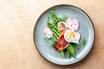 Asparagus and poached eggs with jamon and radishes
