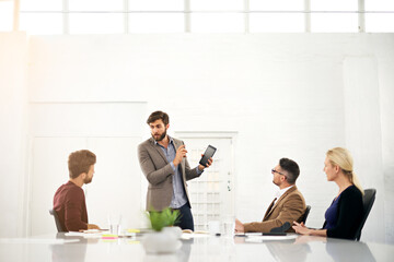 Businessman, coach and talking with tablet for team meeting, presentation or collaboration at office. Man or speaker explaining to group of employees with technology for innovation at conference