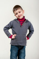 six year old boy stay posing over white studio background
