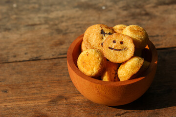 Kue bolu kering or Dried sponge cake in a small wooden bowl with wooden background