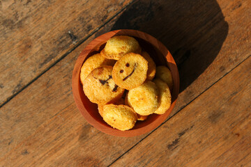 Kue bolu kering or Dried sponge cake in a small wooden bowl with wooden background