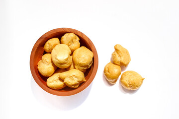 Dry Soes Cake in a small wooden bowl isolated on white background