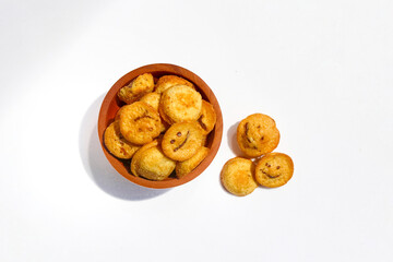 Kue bolu kering or Dried sponge cake in a small wooden bowl isolated on white background
